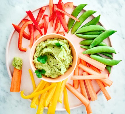 Vegetables on platter with hummus in bowl