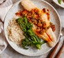 Basa fillet with garlic, spring onion & paprika butter Basa fillet on a plate with rice and tenderstem broccoli