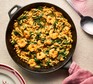 Creamy Cajun prawn orzo sits in a skillet pan