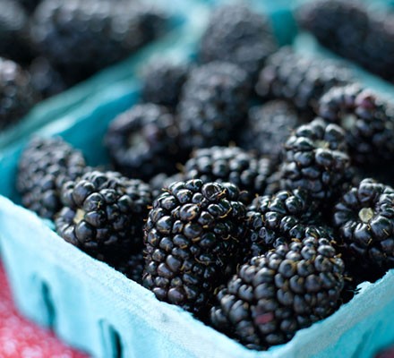 Fresh blackberries in baskets at market