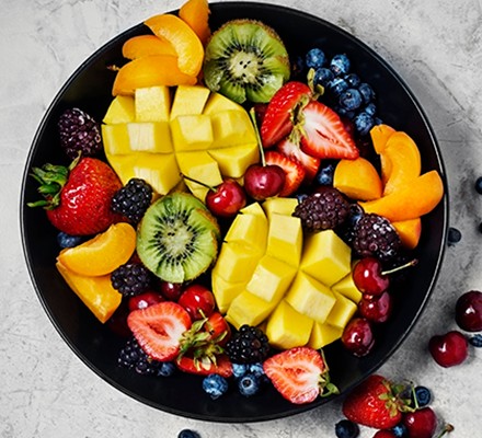 Fresh fruit in a black bowl