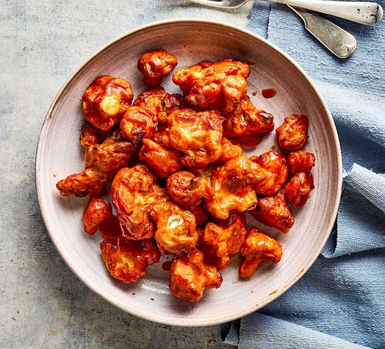 Air-fryer buffalo cauliflower wings in a large sharing bowl