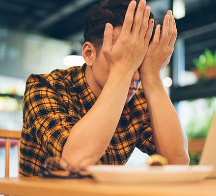 A young man appearing stressed