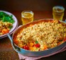 Butternut squash & cherry tomato crumble in a baking dish