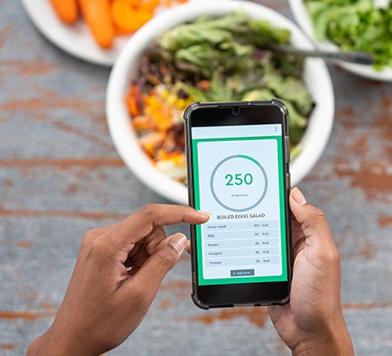 Someone using a smartphone to work out calories in foods