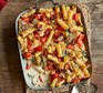 Chicken, spinach and bacon alfredo pasta bake in a baking dish