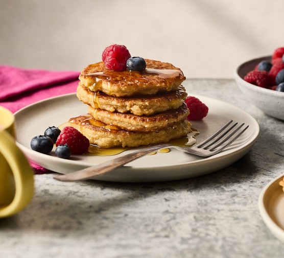 A stack of cottage cheese pancakes topped with berries