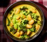 Curried bean stew with coconut & coriander drizzle A serving of curried bean stew with coconut & coriander drizzle
