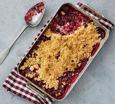 Damson crumble served in a dish
