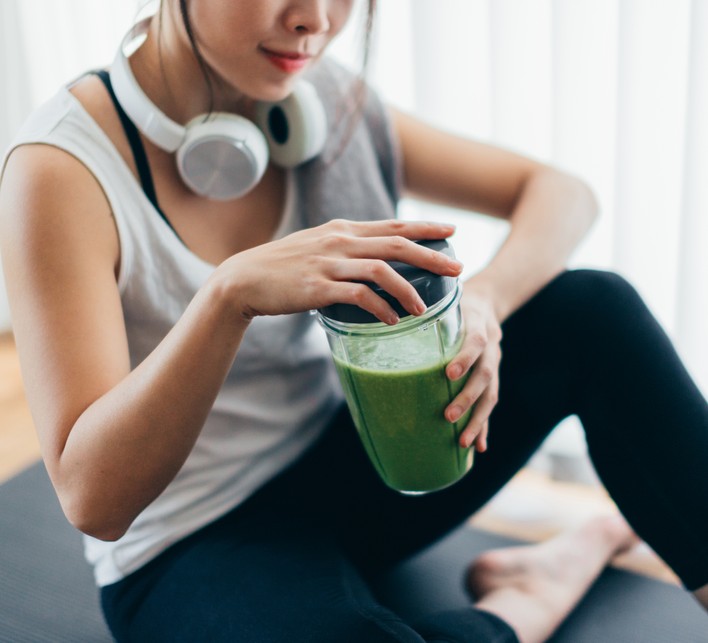 Everything you need to know about protein Young woman drinking green smoothie after yoga