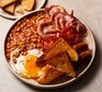 Full English breakfast on a plate with fried bread