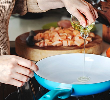 Pouring olive oil into a pan