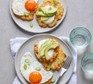 Potato fritters topped with egg, soured cream and avocado