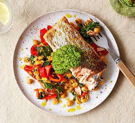 Salsa verde salmon with smashed chickpea salad served on a plate