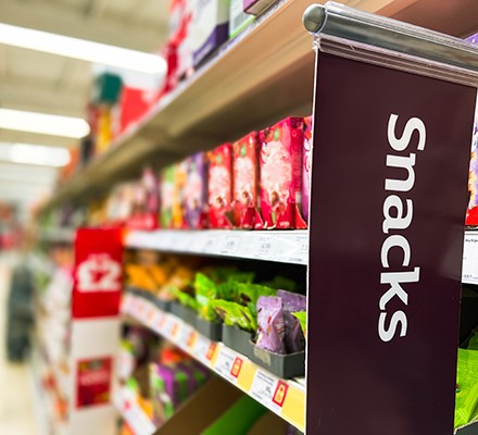 Is snacking bad for you? A supermarket sign saying 'snacks'