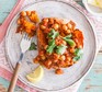 Low-salt lunch recipes Vegan chickpea curry jacket potato on a plate with a slice of lemon and fork alongside