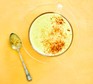 Turmeric latte recipe Latte with turmeric topping in cup with spoon