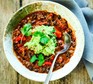 Mexican bean soup with guacamole Mexican bean soup with guacamole in a bowl with a spoon