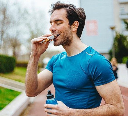 Man eating energy bar