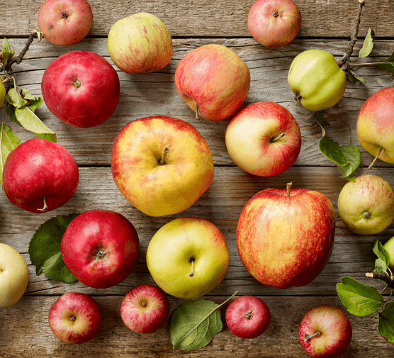 Apples scattered on a wooden surface